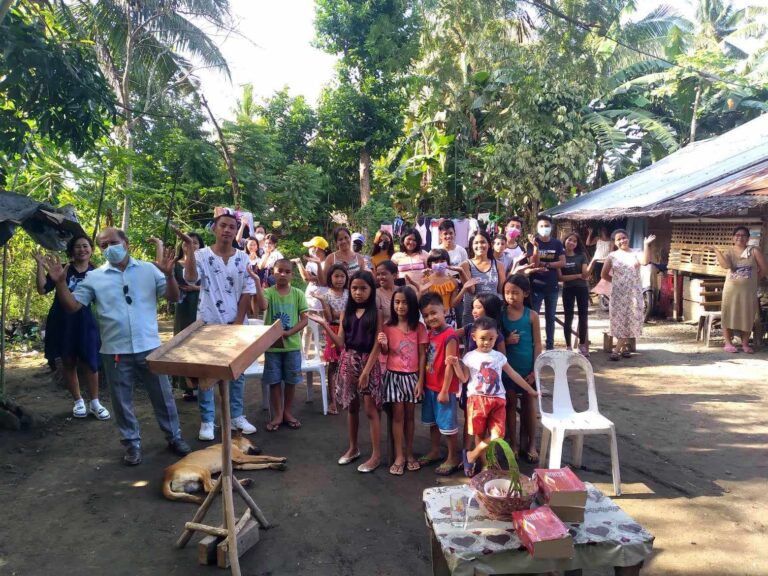 Tangalan congregation contemplating the new chapel to be built behind where they are standing - October 2023